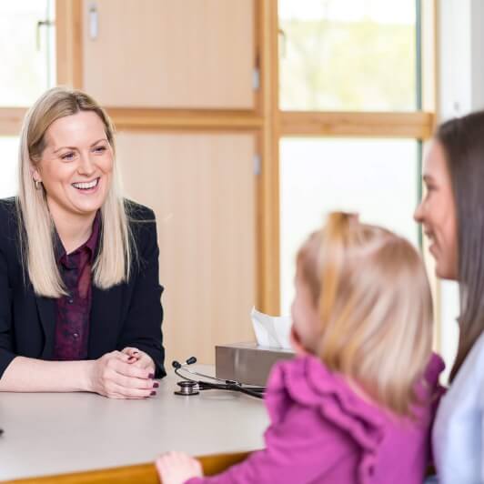 Woman and child talking to female consultant